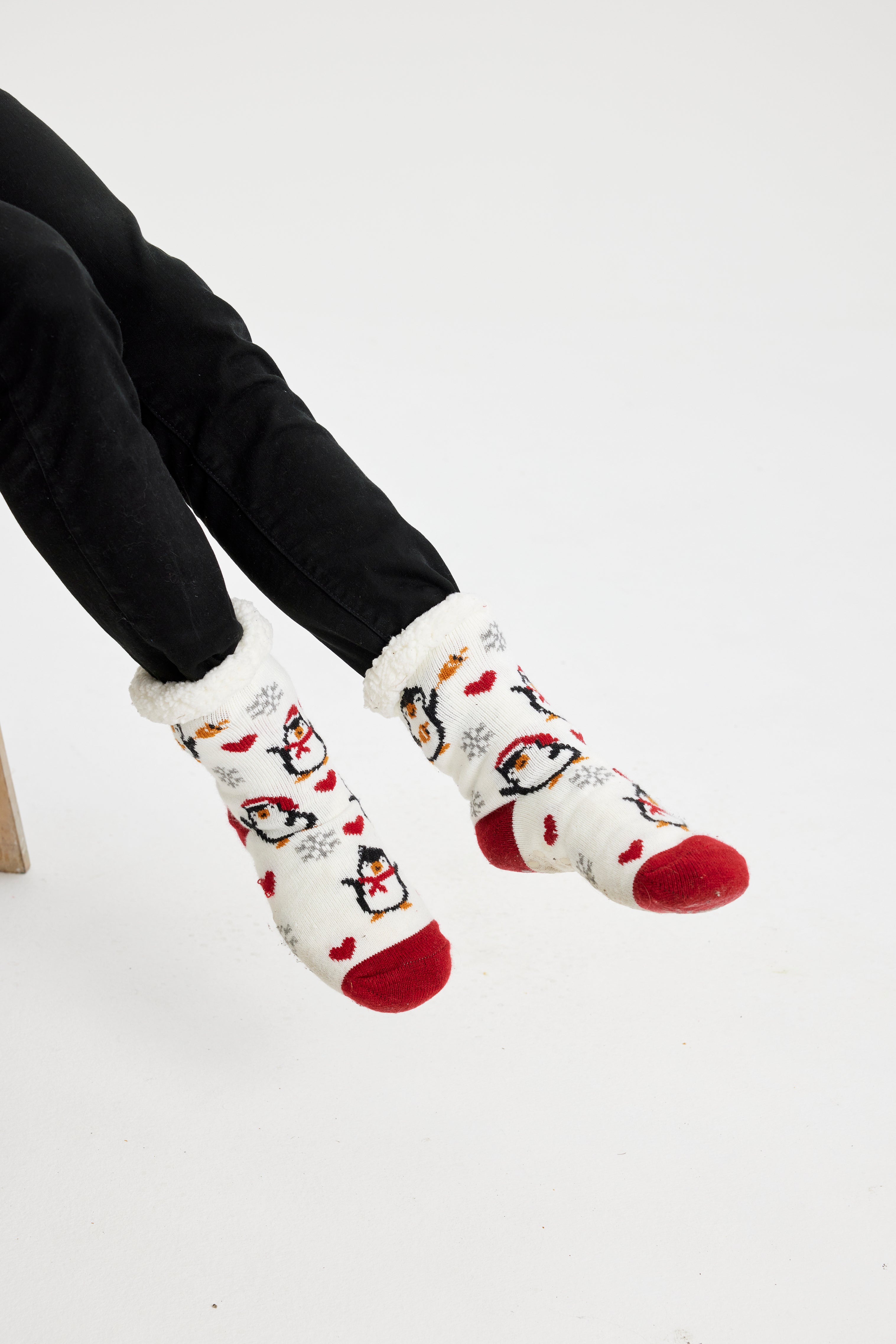 Un paio di piedi che indossano un paio di calzini di Natale bianchi e rossi.